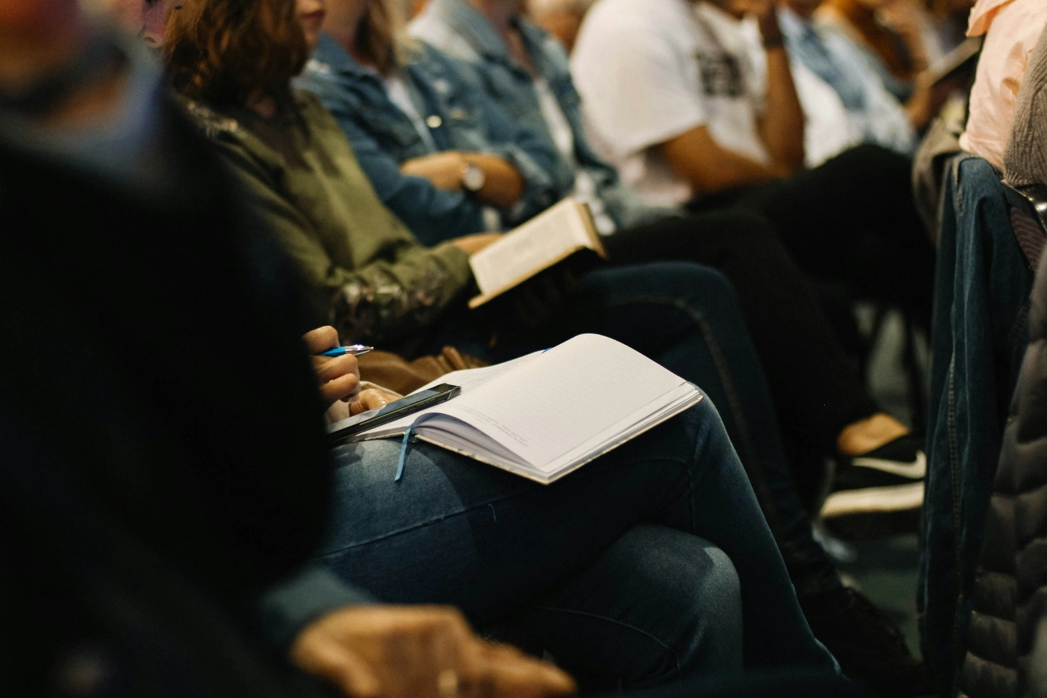 People studying with open Bibles and notebooks