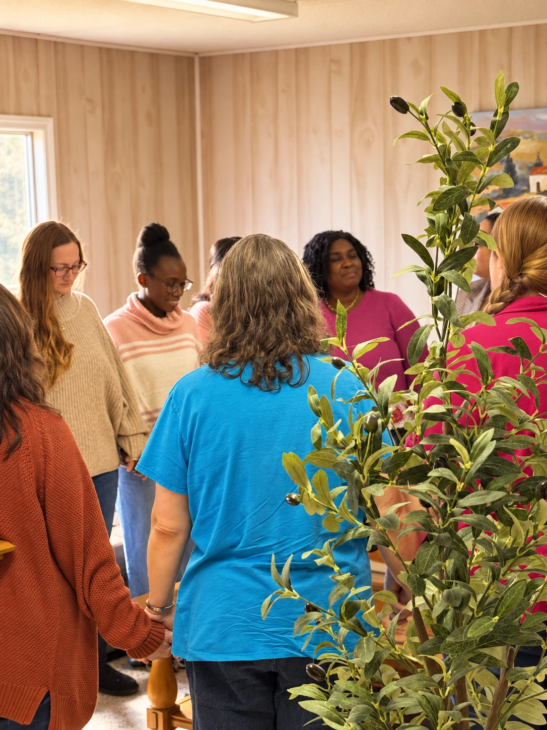Women holding hands in a community group at Clover Community Church